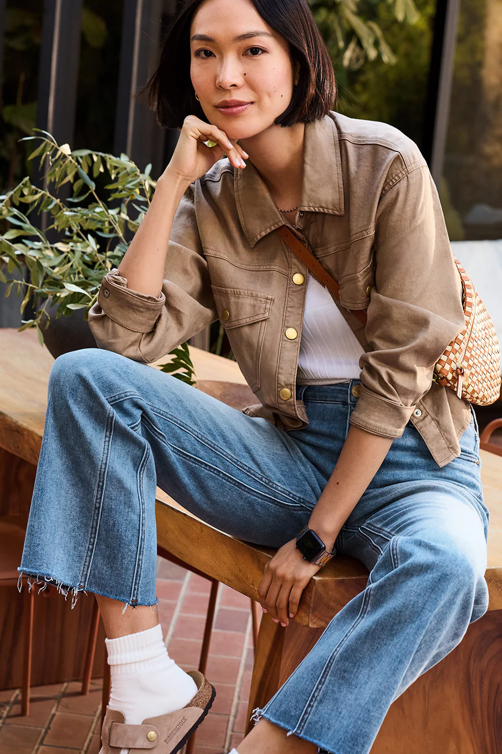 How to find the perfect jeans: denim expertise revealed through expert jean fitting of raw-hem flares, styled casually with a powder blue cardigan and accessories