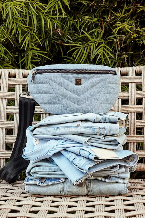 A stack of powder blue denim outfits, showcasing the latest denim trends.